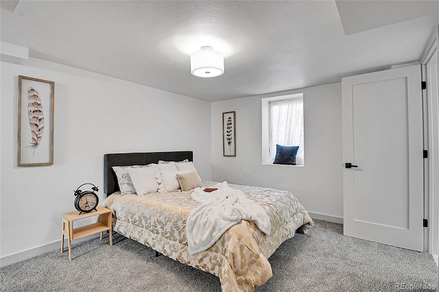 carpeted bedroom with baseboards and a textured ceiling