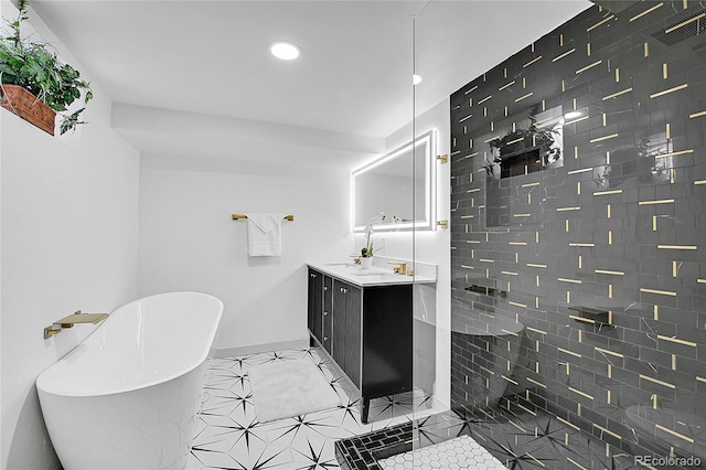 full bathroom featuring a tile shower, a soaking tub, baseboards, vanity, and recessed lighting