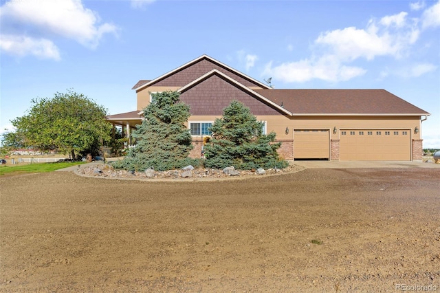 32401 E 147th Ave, Brighton, CO 80603 - craftsman house featuring dirt driveway, an attached garage, and brick siding