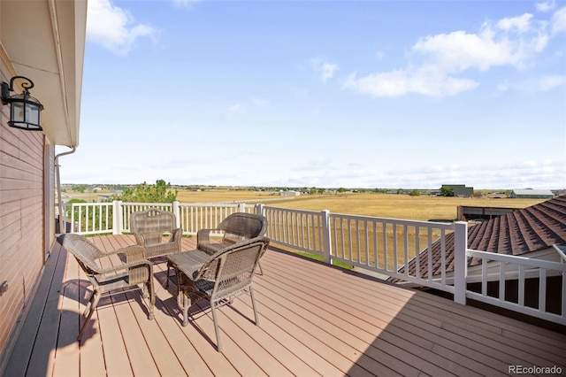 32401 E 147th Ave, Brighton, CO 80603 - wooden deck with outdoor dining space and a view of countryside