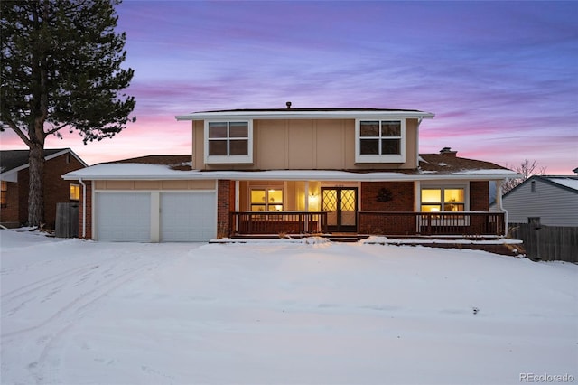 view of property featuring covered porch and a garage