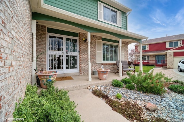 property entrance featuring brick siding and covered porch