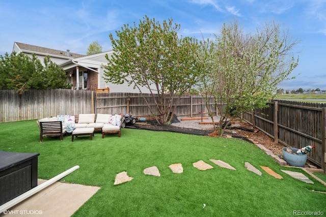 view of yard featuring outdoor lounge area and a fenced backyard