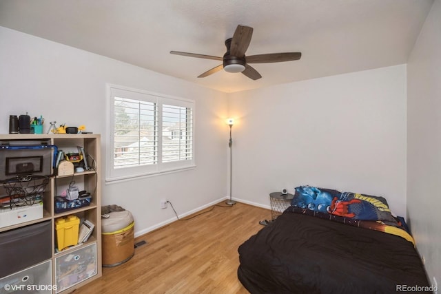 bedroom featuring baseboards, ceiling fan, light wood finished floors, and visible vents