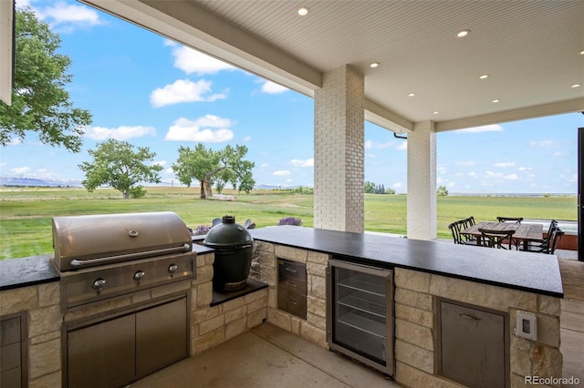 view of patio / terrace featuring wine cooler, exterior kitchen, and area for grilling