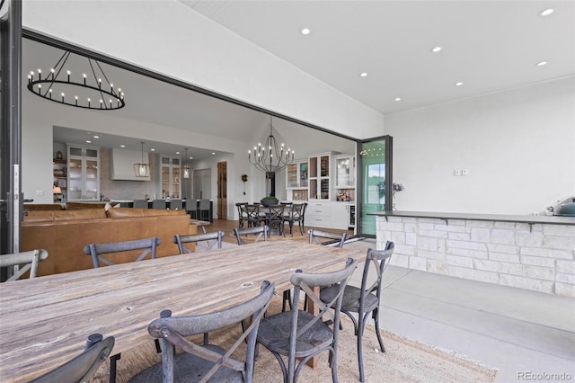 dining room with an inviting chandelier and concrete floors