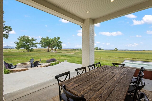 view of patio featuring a rural view and a fire pit