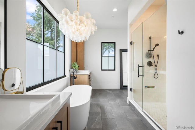 bathroom with a notable chandelier, tile flooring, independent shower and bath, and vanity