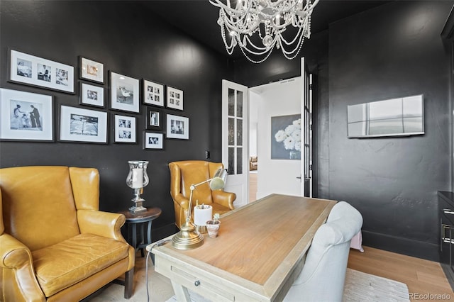 office space featuring light hardwood / wood-style floors and an inviting chandelier