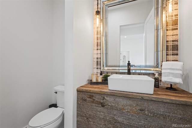 bathroom with toilet and vanity