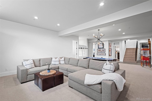 carpeted living room with a notable chandelier