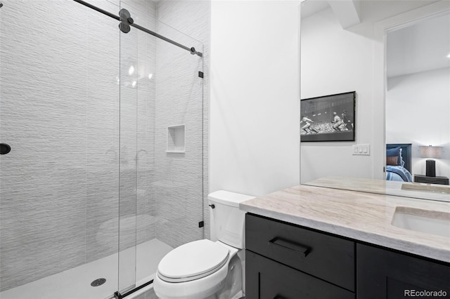 bathroom with walk in shower, vanity, and toilet