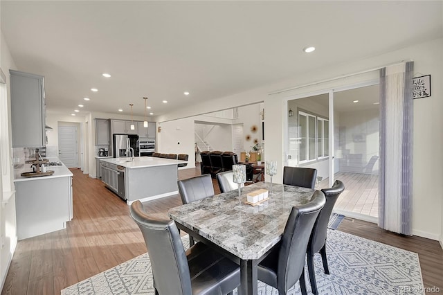 dining room with light hardwood / wood-style floors and sink