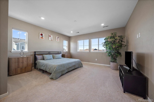 carpeted bedroom with multiple windows