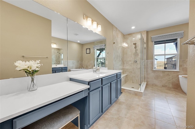 bathroom featuring tile patterned floors, tile walls, toilet, walk in shower, and vanity