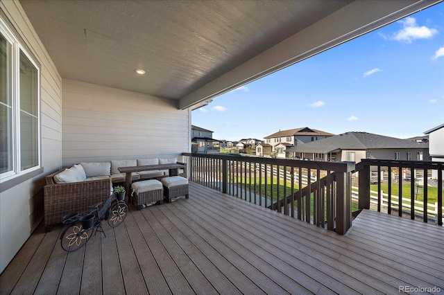 wooden deck with an outdoor living space