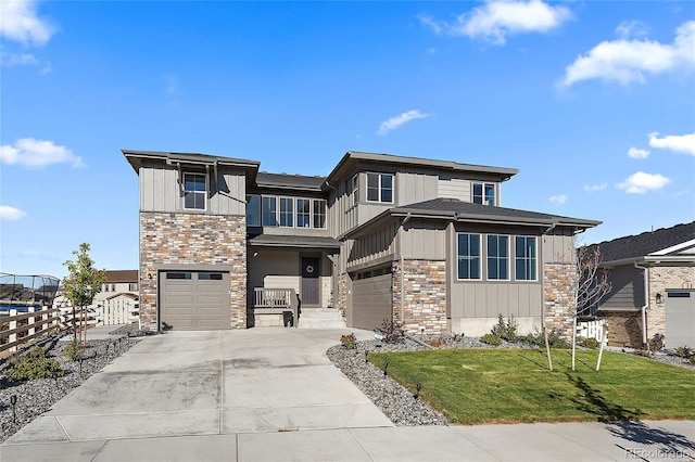 view of front of house featuring a garage and a front yard