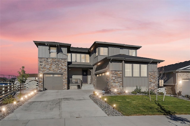 view of front of property with a lawn and a garage