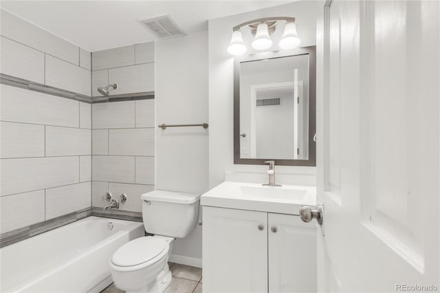 full bathroom featuring tile patterned floors, vanity, toilet, and tiled shower / bath combo