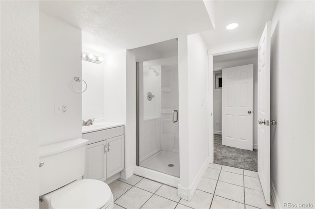 bathroom featuring vanity, tile patterned floors, a shower with door, and toilet