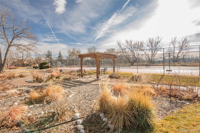 view of yard featuring a pergola and tennis court