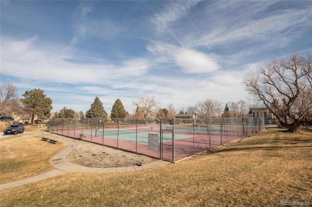 view of sport court featuring a lawn