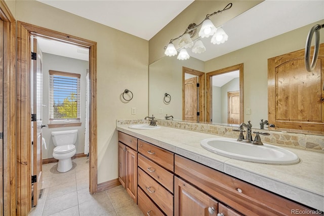 bathroom with tile patterned floors, vanity, and toilet