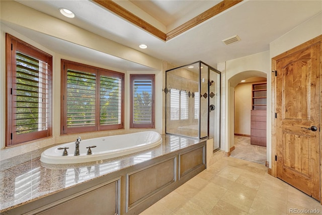 bathroom featuring independent shower and bath