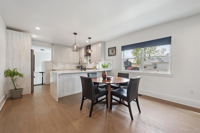 dining area with baseboards, recessed lighting, and wood finished floors