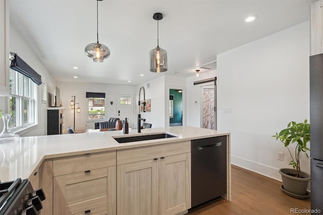 kitchen featuring light countertops, a sink, light brown cabinetry, and dishwasher