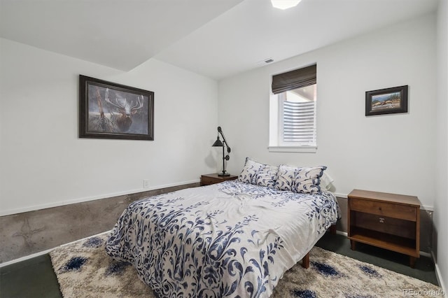 bedroom featuring baseboards, concrete flooring, and visible vents