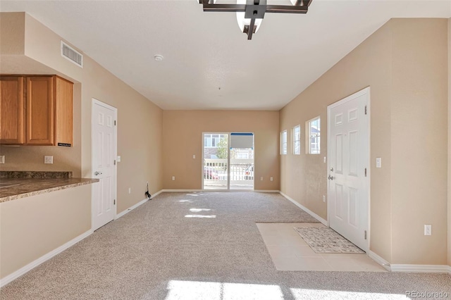 foyer featuring light carpet, baseboards, and ceiling fan