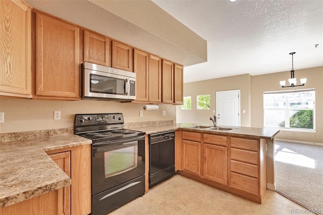 kitchen with black appliances, a sink, a peninsula, a chandelier, and light countertops