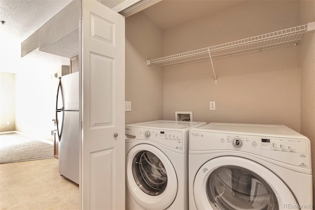 clothes washing area with independent washer and dryer