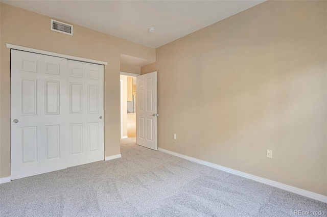 unfurnished bedroom with carpet floors, baseboards, and a closet