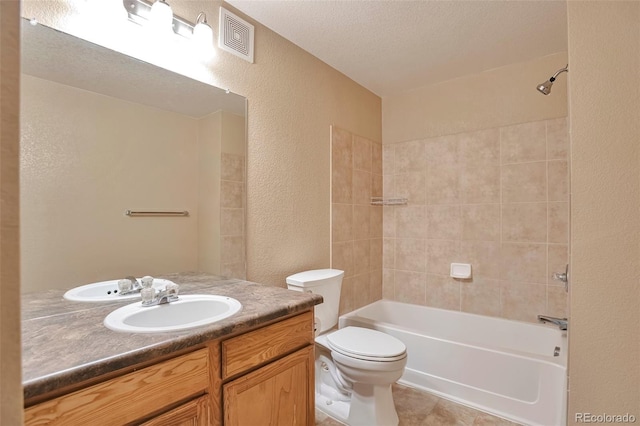 bathroom with a textured wall, toilet, vanity, shower / bathtub combination, and tile patterned flooring