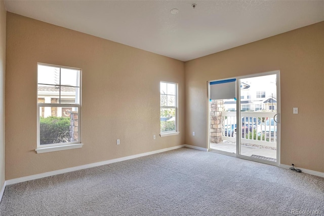 spare room with carpet floors and baseboards