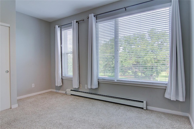 empty room with carpet flooring, baseboards, and baseboard heating