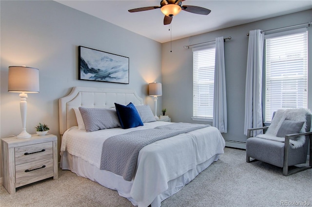 bedroom with a baseboard heating unit, light carpet, and a ceiling fan