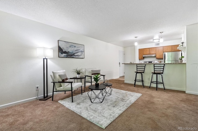 carpeted living room featuring a textured ceiling