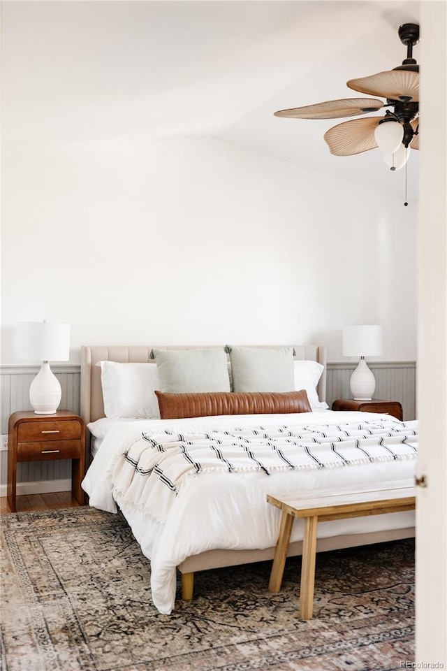 bedroom featuring ceiling fan, vaulted ceiling, and wood-type flooring