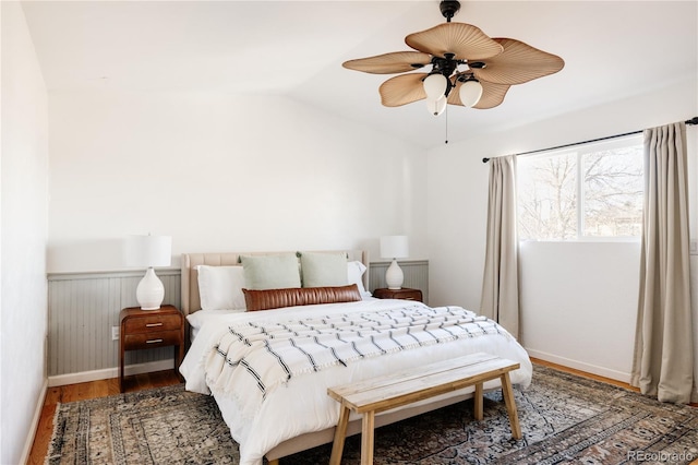 bedroom featuring hardwood / wood-style floors, vaulted ceiling, and ceiling fan