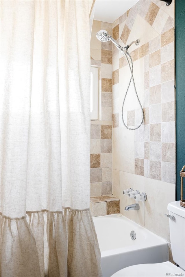 bathroom featuring shower / bath combination with curtain and toilet