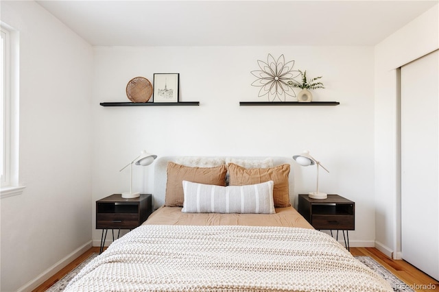 bedroom featuring hardwood / wood-style floors and a closet