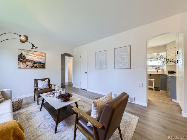 9540 King Way, Westminster, CO 80031 - living room featuring arched walkways and light wood-type flooring