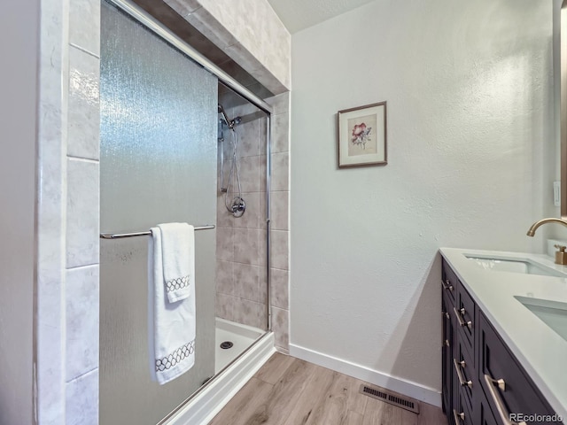 9540 King Way, Westminster, CO 80031 - bathroom featuring wood finished floors, a stall shower, and double vanity