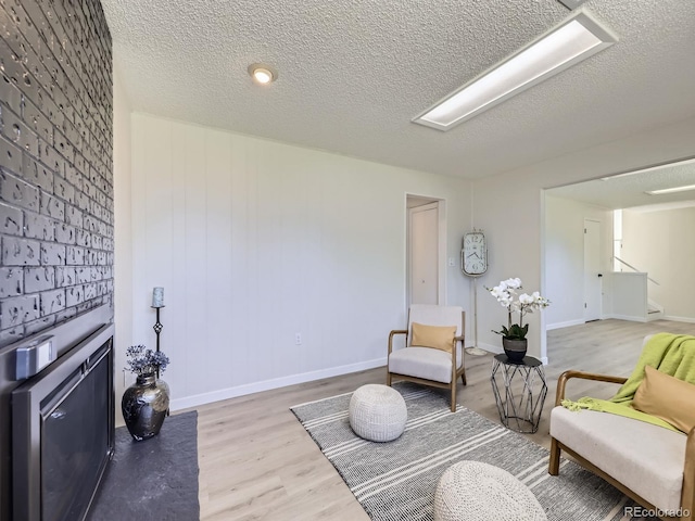 9540 King Way, Westminster, CO 80031 - living area featuring light wood-style flooring, a textured ceiling, and stairs
