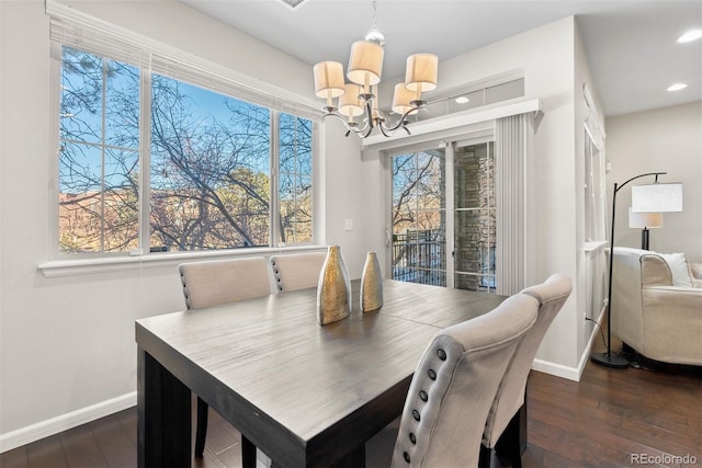 dining room featuring dark hardwood / wood-style floors and a chandelier