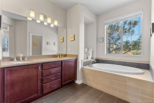 bathroom featuring vanity and tiled bath