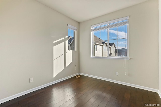 empty room featuring dark hardwood / wood-style flooring